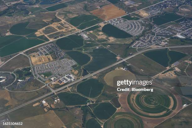 Suburban tract housing and agricultural land watered by center-pivot irrigation systems outside Denver, Colorado, US, on Saturday, Aug. 19, 2023....