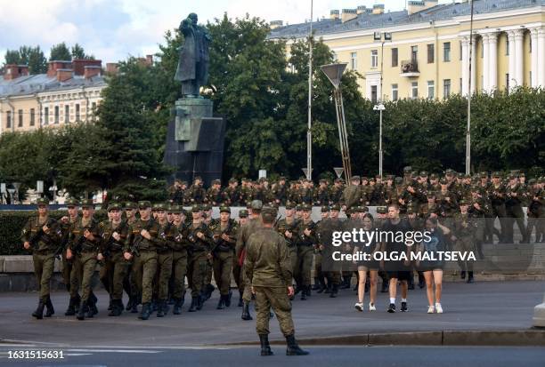 Cadets of the Mikhailov Military Artillery Academy march in front of a statue of the founder of the Soviet Union Vladimir Lenin in Saint Petersburg...