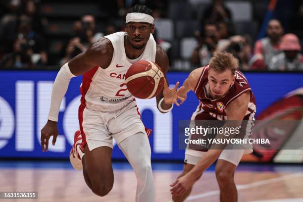 Canada's Shai Gilgeous-Alexander dribbles past Latvia's Arturs Zagars during the FIBA Basketball World Cup group H match between Canada and Latvia at...