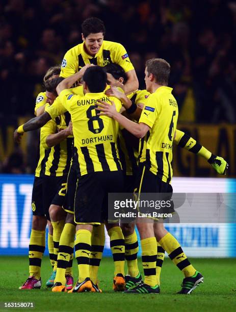 Felipe Santana of Dortmund celebrates with team mates after scoring his teams first goal during the UEFA Champions League round of 16 second leg...