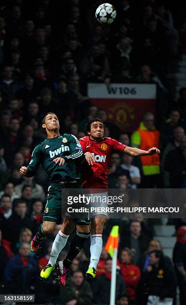Real Madrid's Portuguese forward Cristiano Ronaldo and Manchester United's Brazilian defender Rafael jump for the ball during the UEFA Champions...