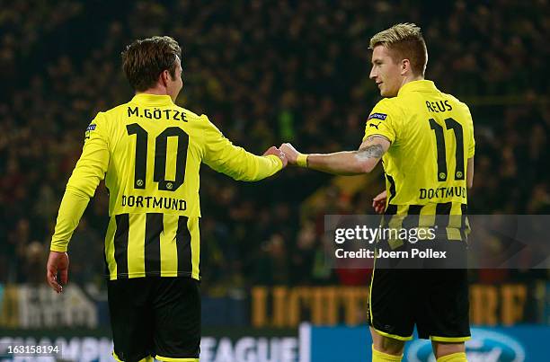 Mario Goetze of Dortmund celebrates with his team mate Marco Reus after scoring his team's second goal during the UEFA Champions League round of 16...