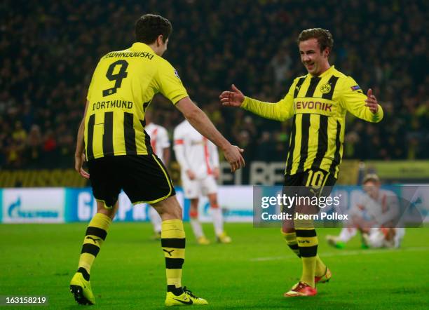 Mario Goetze of Dortmund celebrates with his team mate Robert Lewandowski after scoring his team's second goal during the UEFA Champions League round...