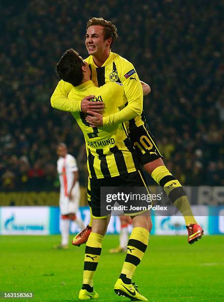 Mario Goetze of Dortmund celebrates with his team mate Robert Lewandowski after scoring his team's second goal during the UEFA Champions League round...