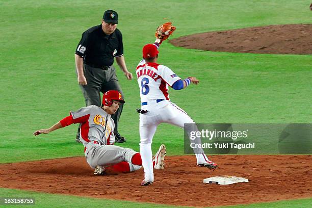 Fujia Chu of Team China steals second base in the top of the fifth inning during Pool A, Game 4 between Team China and Team Cuba during the first...