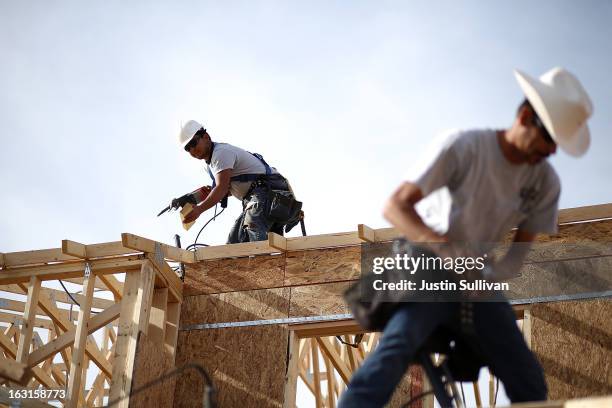 Workers build a new home at the Pulte Homes Fireside at Norterra-Skyline housing development on March 5, 2013 in Phoenix, Arizona. In 2008, Phoenix,...