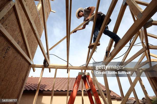 Worker builds a new home at the Pulte Homes Fireside at Norterra-Skyline housing development on March 5, 2013 in Phoenix, Arizona. In 2008, Phoenix,...