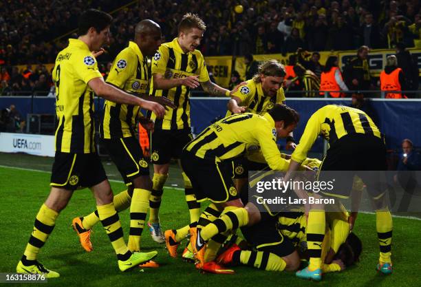 Jakub Blaszczykowski of Dortmund celebrates with team mates after scoring his teams third goal during the UEFA Champions League round of 16 second...