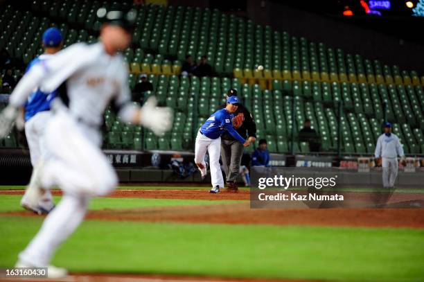 Jeong Choi of Team Korea throws to force out Luke Hughes of Team Australia to end the third inning during Pool B, Game 4 between Team Korea and Team...