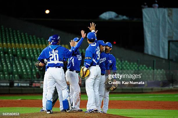 Members of Team Korea celebrate defeating Team Australia in Pool B, Game 4 in the first round of the 2013 World Baseball Classic at Taichung...