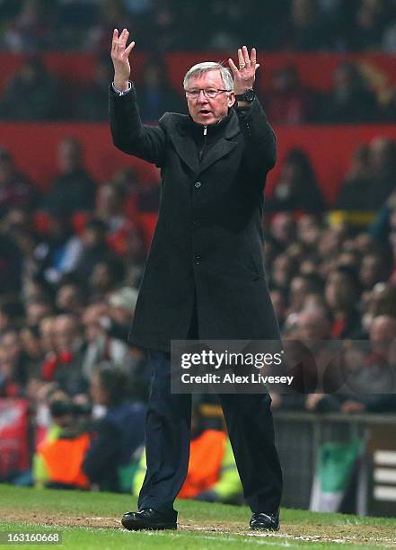 Manchester United Manager Sir Alex Ferguson encourages the crowd to show their support during the UEFA Champions League Round of 16 Second leg match...