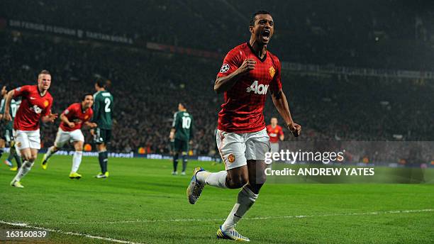 Manchester United's Portuguese midfielder Nani celebrates after Real Madrid's Spanish defender Sergio Ramos scored an own goal during the UEFA...