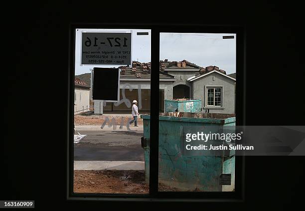 New home under construction is seen through a window at the Pulte Homes Fireside at Norterra-Skyline housing development on March 5, 2013 in Phoenix,...