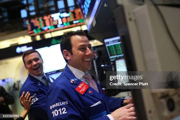 Traders work on the floor of The New York Stock Exchange on March 5, 2013 in New York City. The Dow Jones industrial average rallied to a record high...