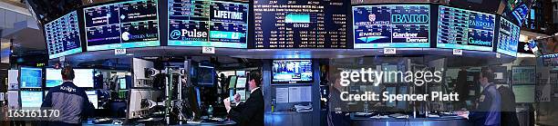 Traders work on the floor of The New York Stock Exchange on March 5, 2013 in New York City. The Dow Jones industrial average rallied to a record high...