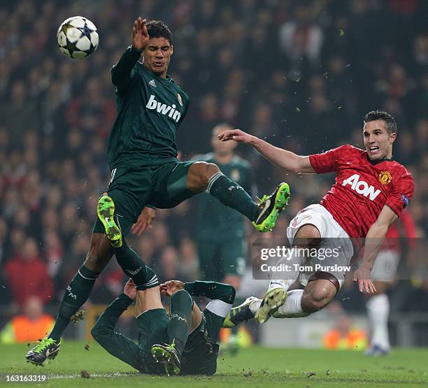 Robin van Persie of Manchester United in action with Raphael Varane of Real Madrid during the UEFA Champions League match between Manchester United...