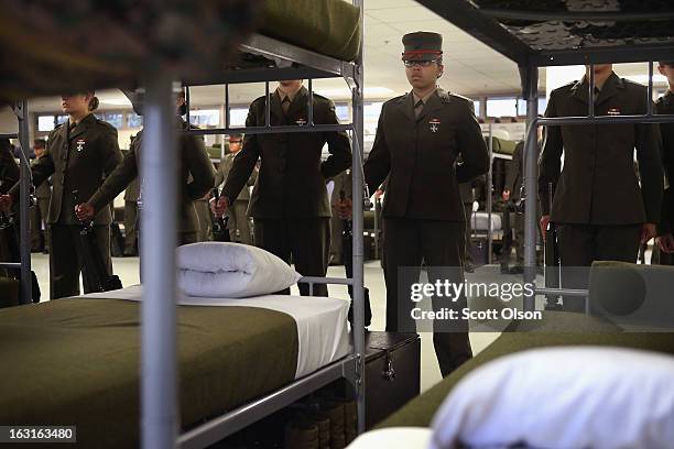 Female Marine recruits stand inspection in the final days of their boot camp training February 26, 2013 at MCRD Parris Island, South Carolina. Female...