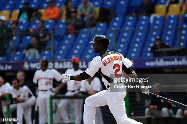 Roger Bernadina of Team Netherlands hits a RBI single in the bottom of the first inning during Pool B, Game 5 between Team Australia and Team...