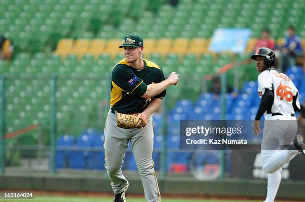 Mike Walker of Team Australia throws to third base in the bottom of the fourth inning during Pool B, Game 5 between Team Australia and Team...