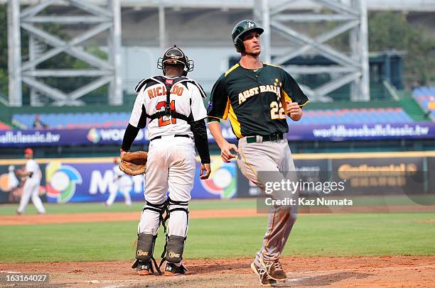 Stefan Welch of Team Australia scores a run in the top of the seventh inning during Pool B, Game 5 between Team Australia and Team Netherlands during...