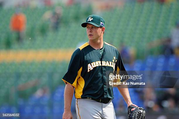 Chris Oxspring of heads back tot he dugout at the end of the third inning during Pool B, Game 5 between Team Australia and Team Netherlands during...