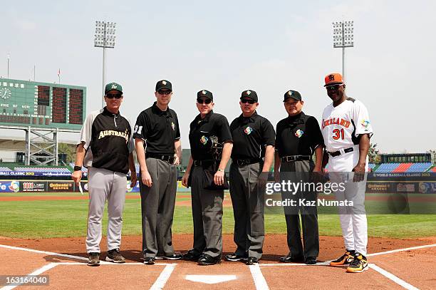 Jon Deeble of Team Australia and Hensley Meulens manager of Team Netherlands pose with the umpiring crew before Pool B, Game 5 between Team Australia...