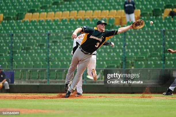 Mike Walker of Team Australia try to catch an errant throw in the bottom of the second inning during Pool B, Game 5 between Team Australia and Team...