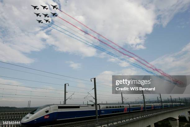 La Patrouille De France Flies Over A Tgv. Les Alphajet de la Patrouille de France lâchant leurs célèbres fumigènes tricolores au-dessus du TGV...