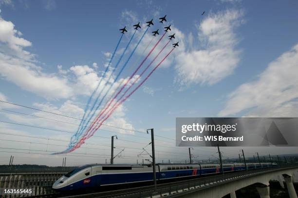 La Patrouille De France Flies Over A Tgv. Les Alphajet de la Patrouille de France lâchant leurs célèbres fumigènes tricolores au-dessus du TGV...