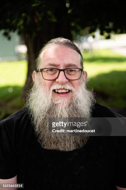 portrait of a senior man with a long beard outdoors in summer. - long beard stock pictures, royalty-free photos & images