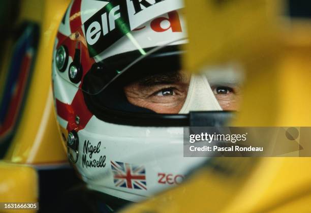 Nigel Mansell from Great Britain checks the lap times from the cockpit of the Canon Williams Renault Williams FW14B Renault V10 during practice for...