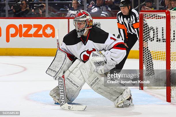 Goaltender Johan Hedberg of the New Jersey Devils gets set in the crease during third-period action against the Winnipeg Jets at the MTS Centre on...