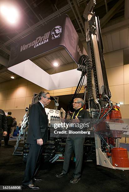 Joe Oliver, Canada's natural resources minister, left, speaks with Serge Bellefeville, a representative with VersaDrill, at the Prospectors and...