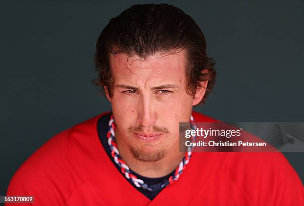 Starting pitcher Derek Holland of Team USA sits in the dugout during the spring training game against the Chicago White Sox at Camelback Ranch on...