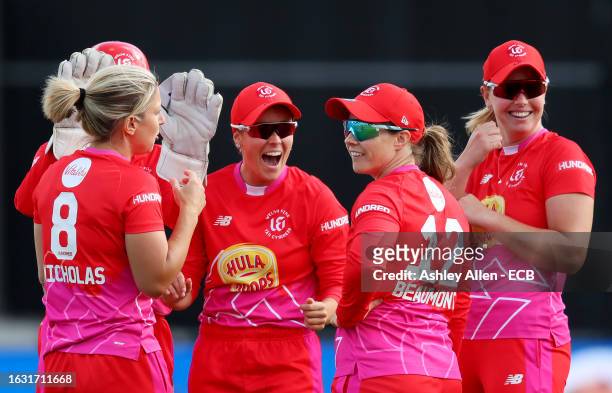 Alex Hartley of Welsh Fire celebrates with teammates after taking the wicket of Phoebe Litchfield of Northern Superchargers after being caught and...