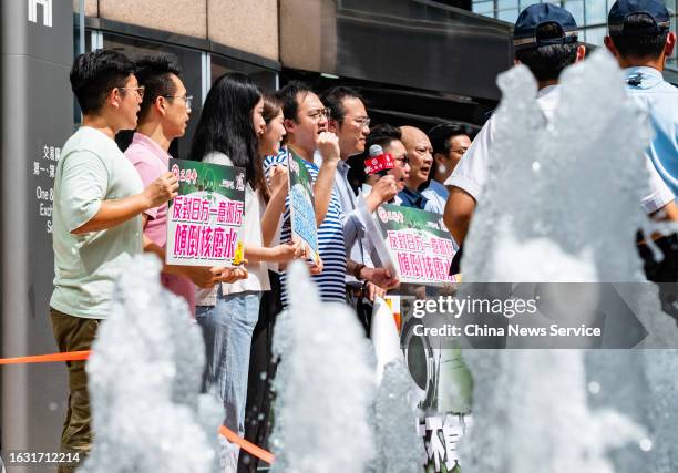 Members of the Hong Kong Federation of Trade Unions gather outside the Japanese consulate during a protest against Japan's plan to release...