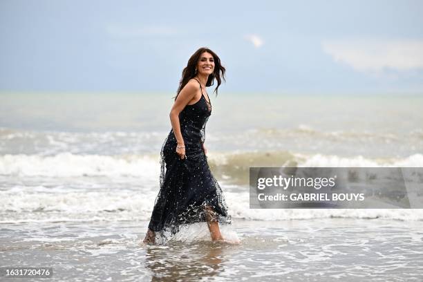 Italian actress Caterina Murino, patroness of the 80th Venice International Film Festival, poses for photographers on August 29, 2023 during a photo...