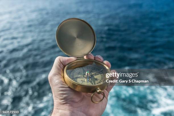 antique brass compas and ocean - navigational equipment stock pictures, royalty-free photos & images