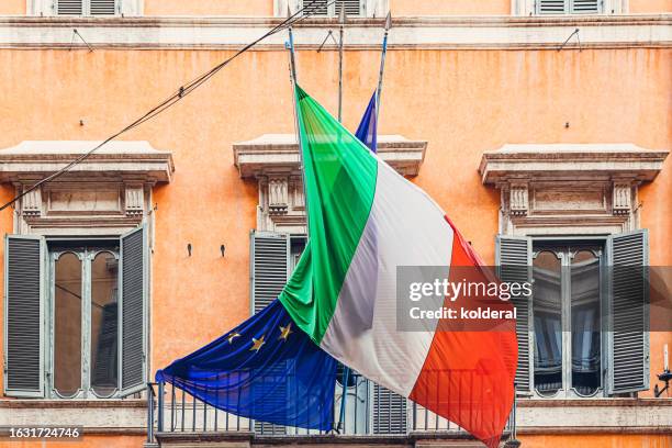 italian and european union flags in historic district of rome, italy - ancient roman flag stock pictures, royalty-free photos & images