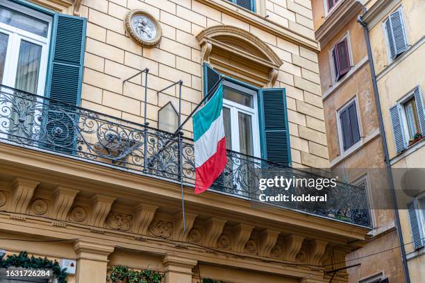 italian flag on balcony in historic district of rome, italy - italian flag stock pictures, royalty-free photos & images