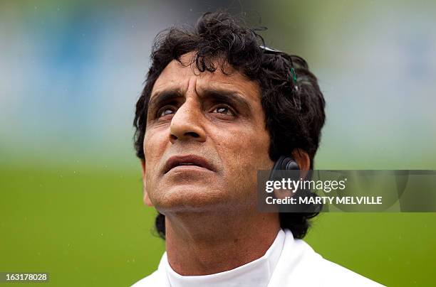 Umpire Asad Rauf from Pakistan checks the weather after a rain storm delayed the start of the game during day one of the first international cricket...