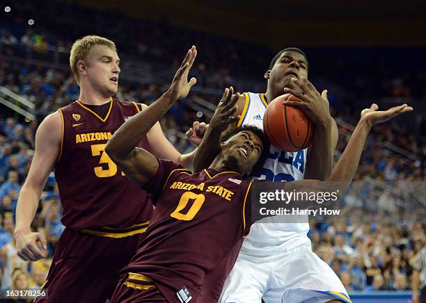 Tony Parker of the UCLA Bruins grabs a rebound from Carrick Felix and Jonathan Gilling of the Arizona State Sun Devils during a 79-74 UCLA win at...