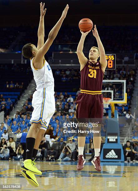Jonathan Gilling of the Arizona State Sun Devils shoots over Kyle Anderson of the UCLA Bruins at Pauley Pavilion on February 27, 2013 in Los Angeles,...
