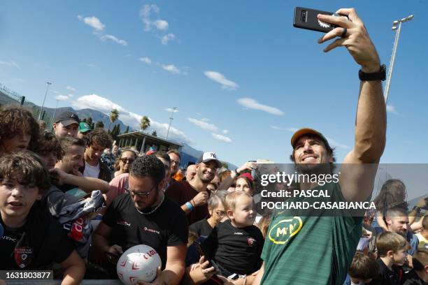 South Africa's lock Eben Etzebeth takes selfies with fans after attending a training session in Biguglia near Bastia on the French Mediterranean...