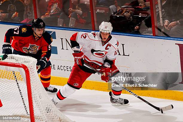 Eric Staal of the Carolina Hurricanes skates with the puck against Marcel Goc of the Florida Panthers at the BB&T Center on March 3, 2013 in Sunrise,...