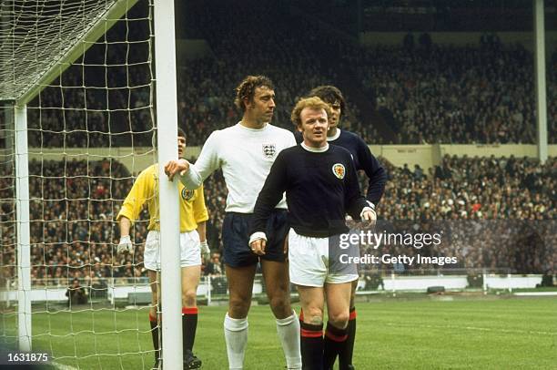 Billy Bremner and Francis Munro of Scotland wait for a cross with Martin Chivers of England during a match at Wembley Stadium in London. England won...