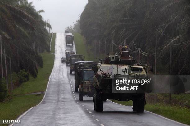 Malaysian soldiers in an armored personnel carrier travel in a convoy in Felda Sahabat on March 6 near the village of Tanduo where Malaysia launched...