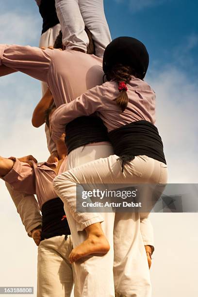 young casteller at human tower. - human pyramid stock pictures, royalty-free photos & images