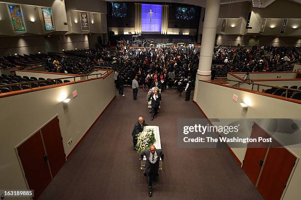 Casket carrying the remains of Darrell Price Jr. And daughter, Patrice Price, foreground is followed by another with the remains of Darrell's...