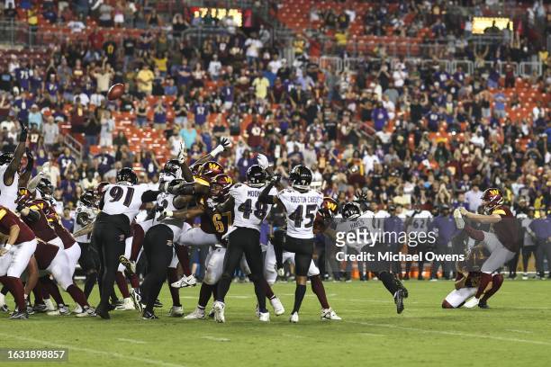 Joey Slye of the Washington Commanders kicks the game winning field goal against the Baltimore Ravens during an NFL preseason game at FedExField on...